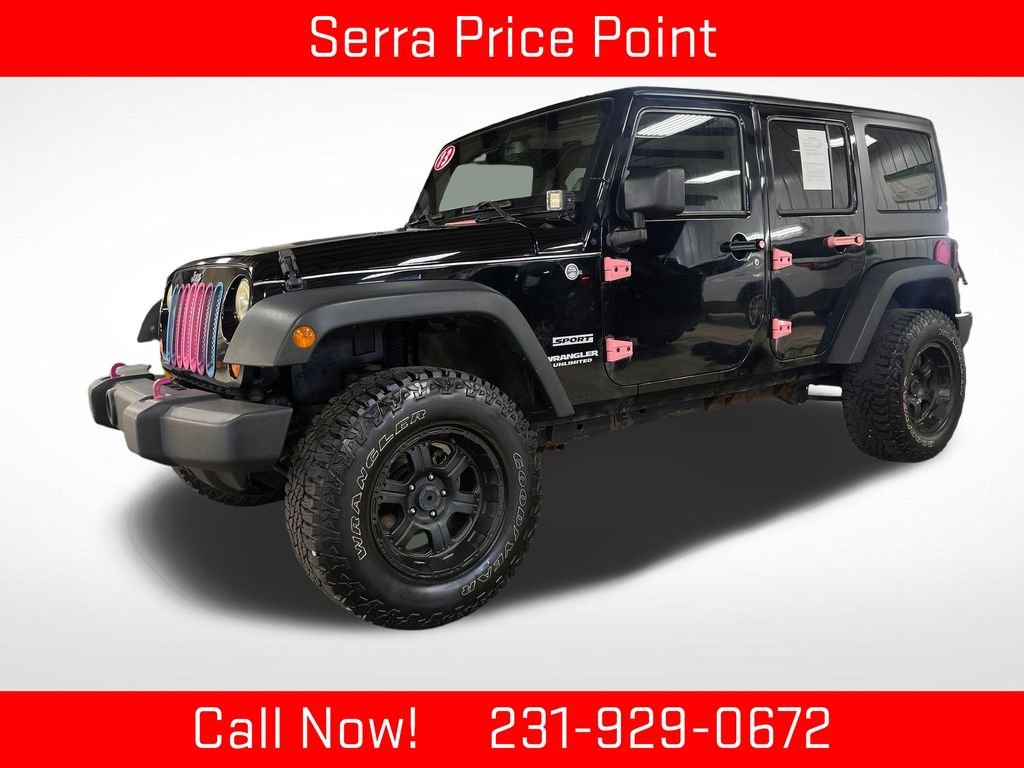 Used 2013 Black Jeep Unlimited Sport image 1