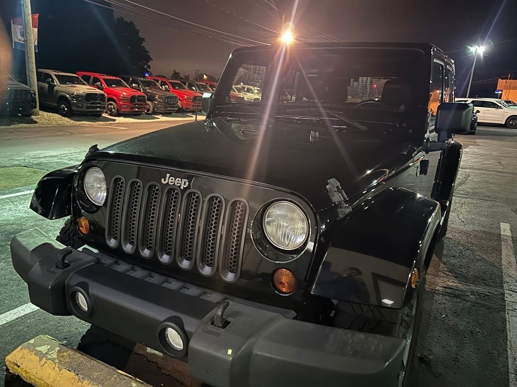 Used 2012 Black Jeep Unlimited Sahara image 1
