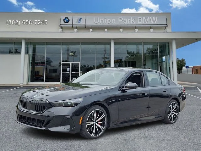 Used 2026 Black Sapphire Metallic BMW 550e xDrive image 1
