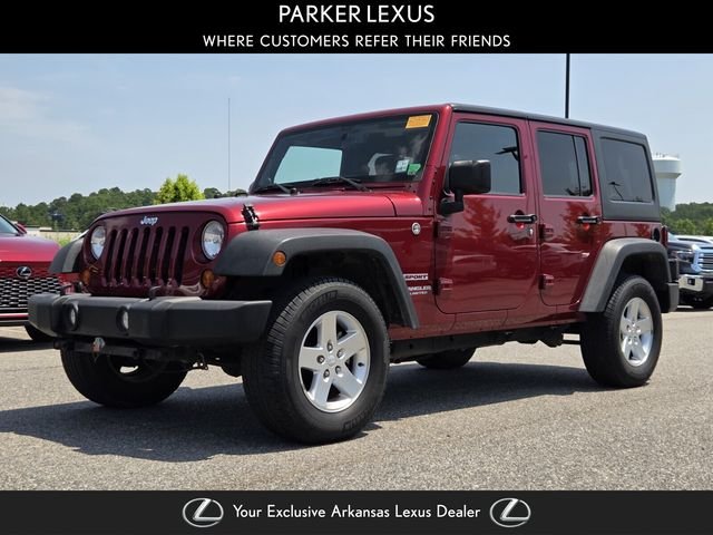 Used 2013 Red Jeep Unlimited Sport image 1