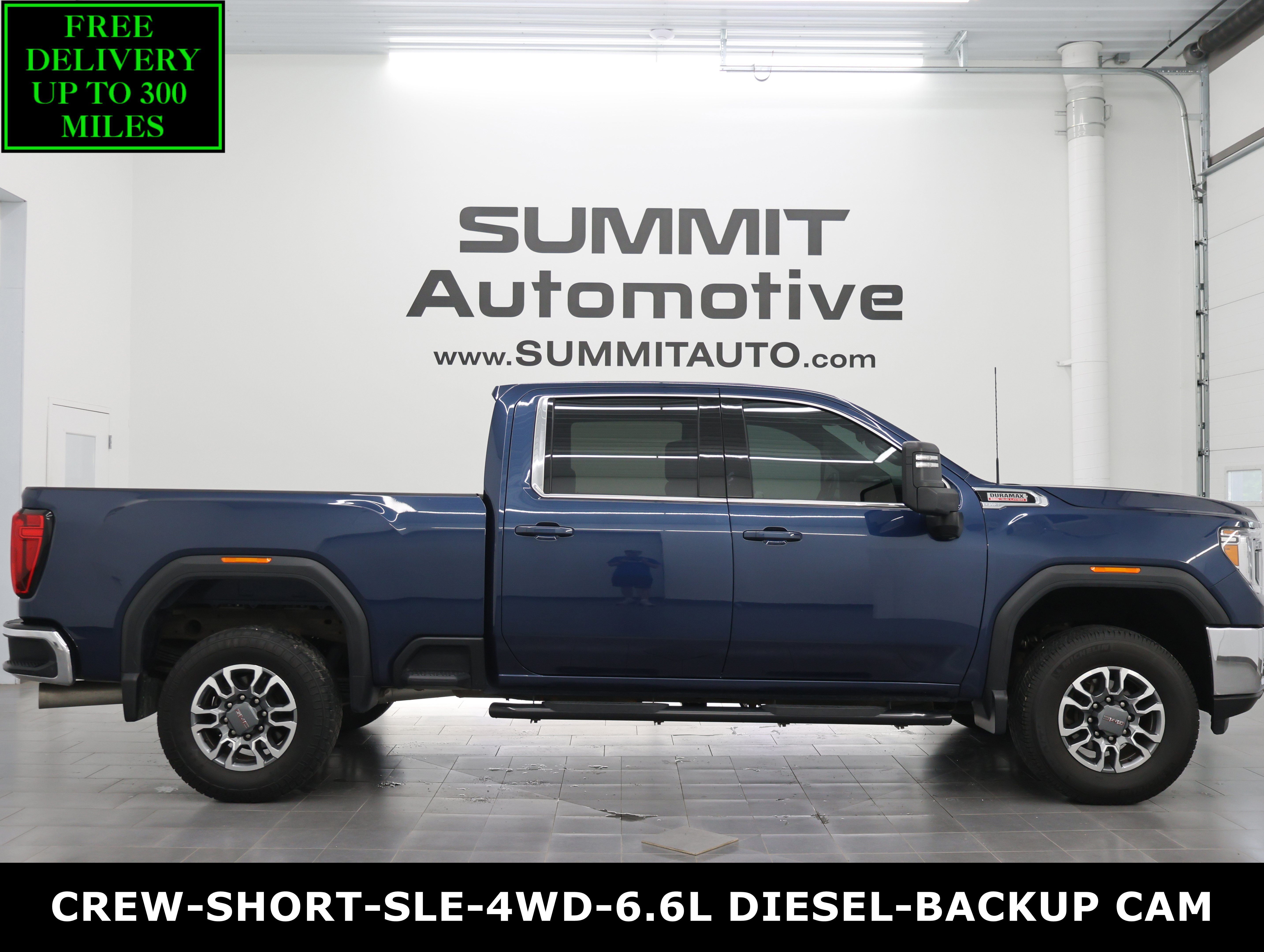 Used 2023 Pacific Blue Metallic GMC 4x4 Crew Cab SLE: CREW-SHORT-SLE-6.6L DIESEL-4WD-BACKUP CAM image 1