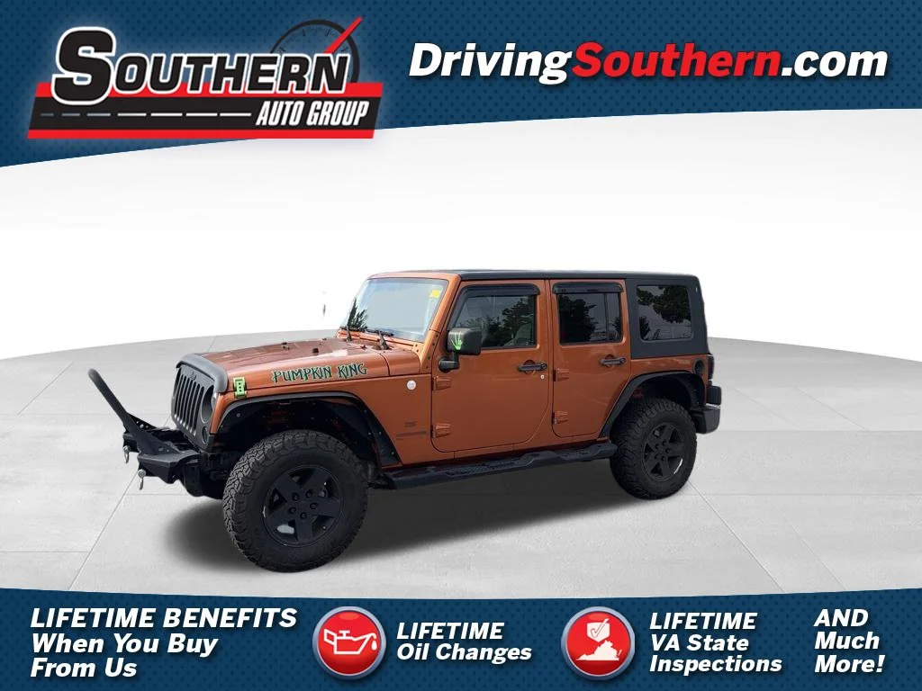 Used 2010 Orange Jeep Unlimited Sport image 1