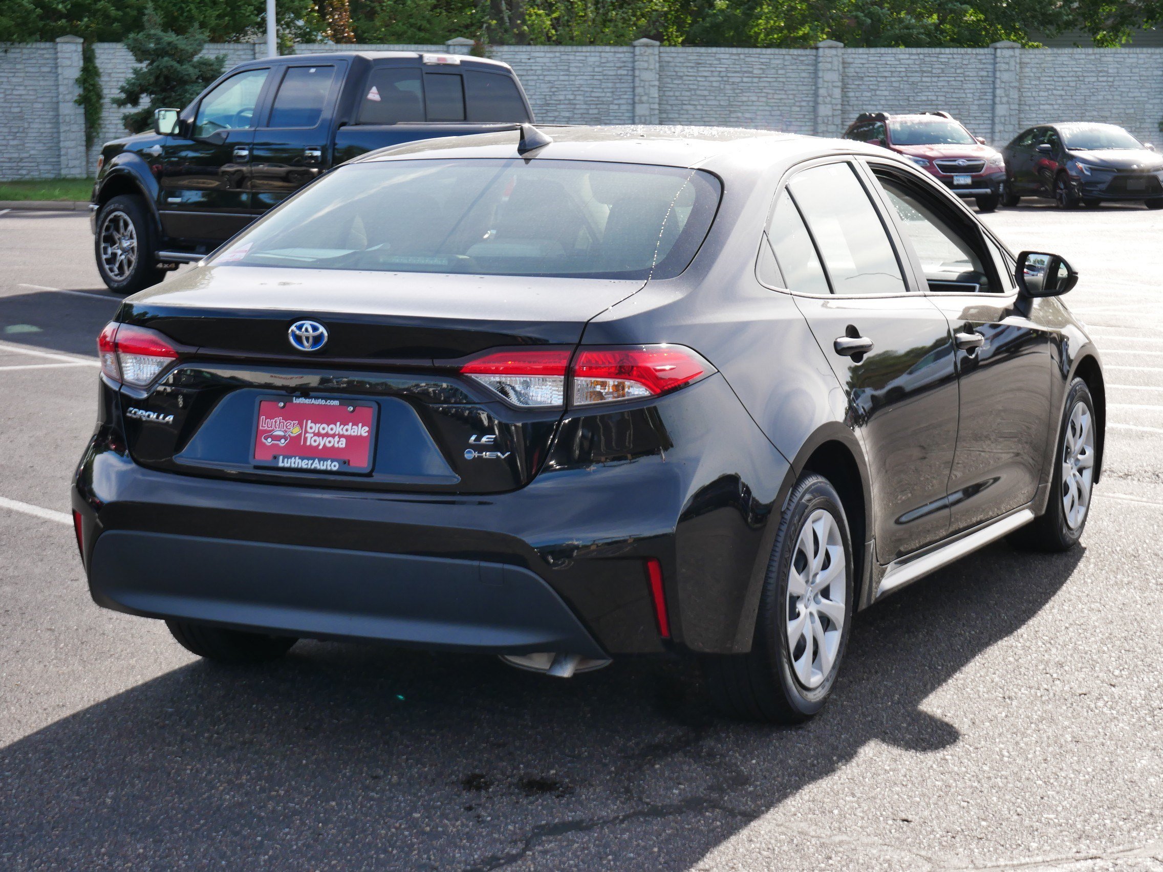 Used 2025 Midnight Black Metallic Toyota Hybrid LE image 6