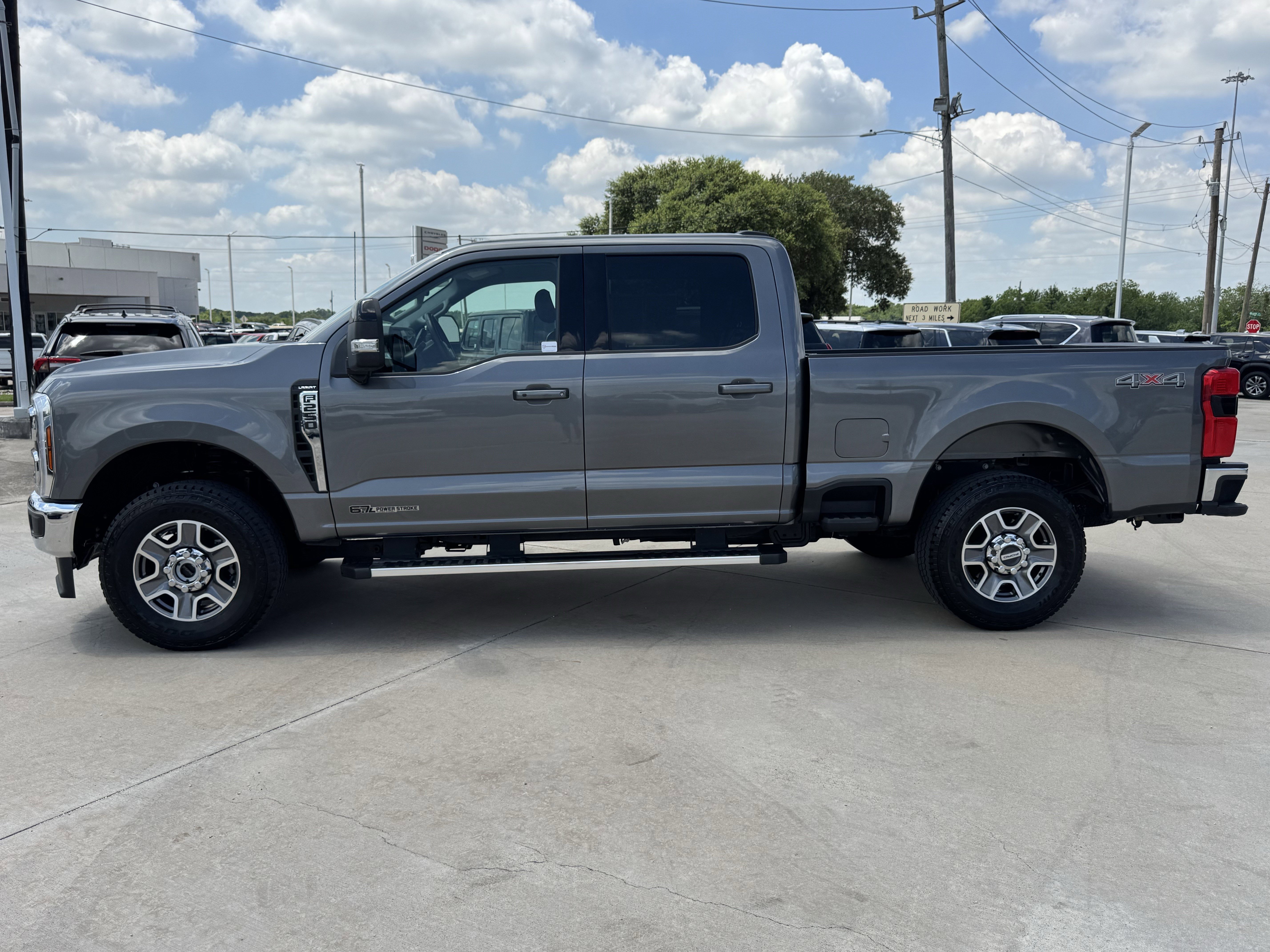 Used 2025 Gray Metallic Ford LARIAT 4WD Crew Cab 6.75