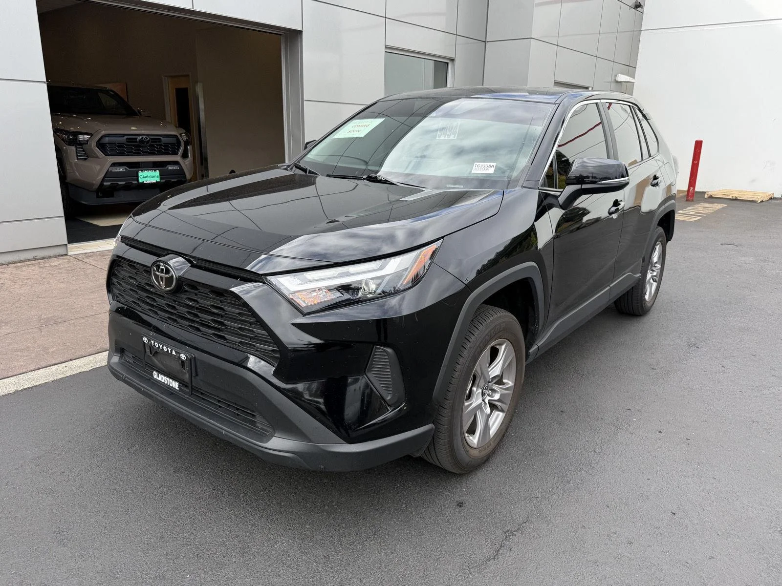 Used 2025 Midnight Black Metallic Toyota LE image 1
