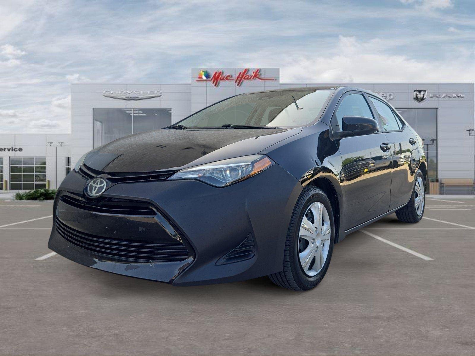 Used 2019 Black Sand Pearl Toyota LE image 1