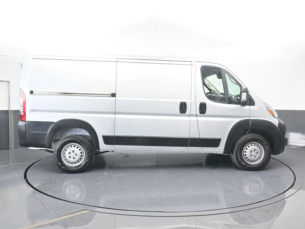 Used 2025 Bright Silver Clearcoat Metallic Ram Low Roof image 7