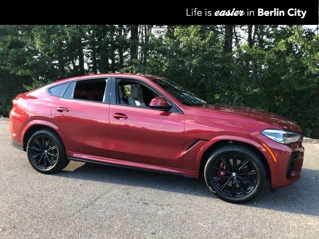 Used 2023 Flamenco Red Metallic BMW xDrive40i image 1
