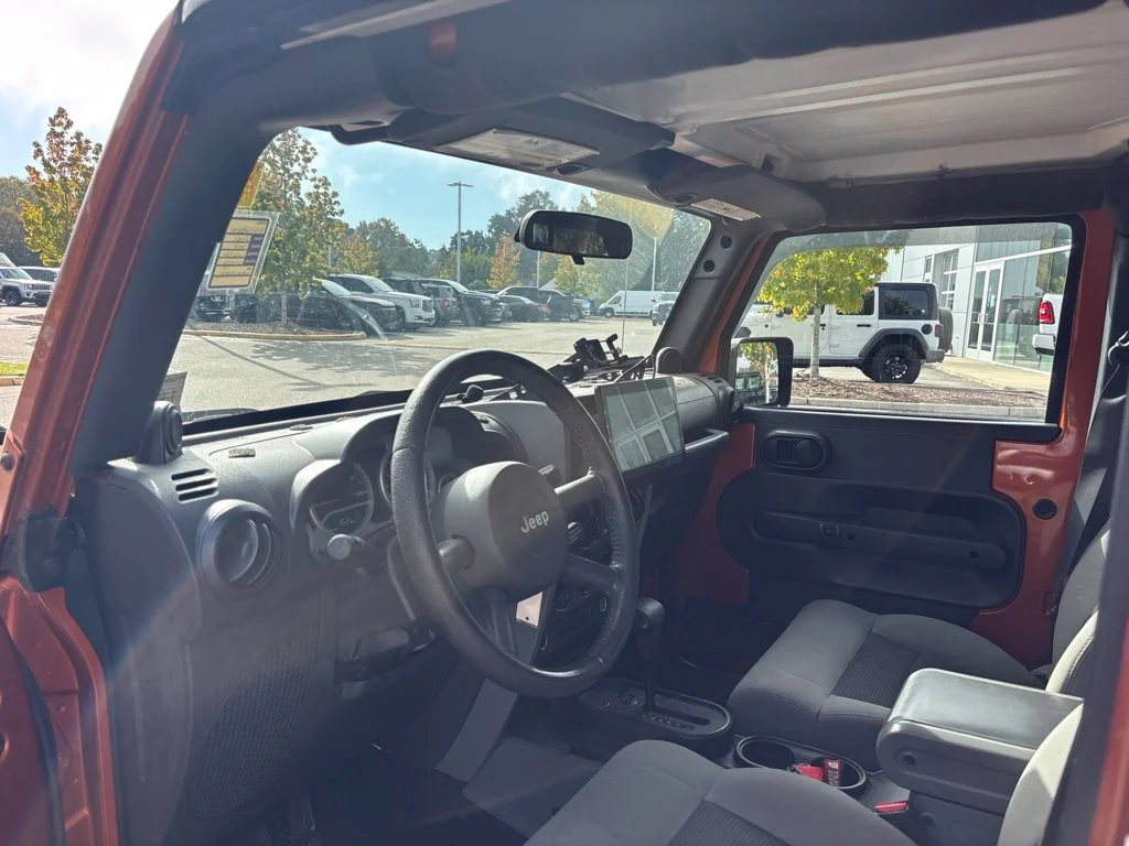 Used 2010 Orange Jeep Unlimited Sport image 8