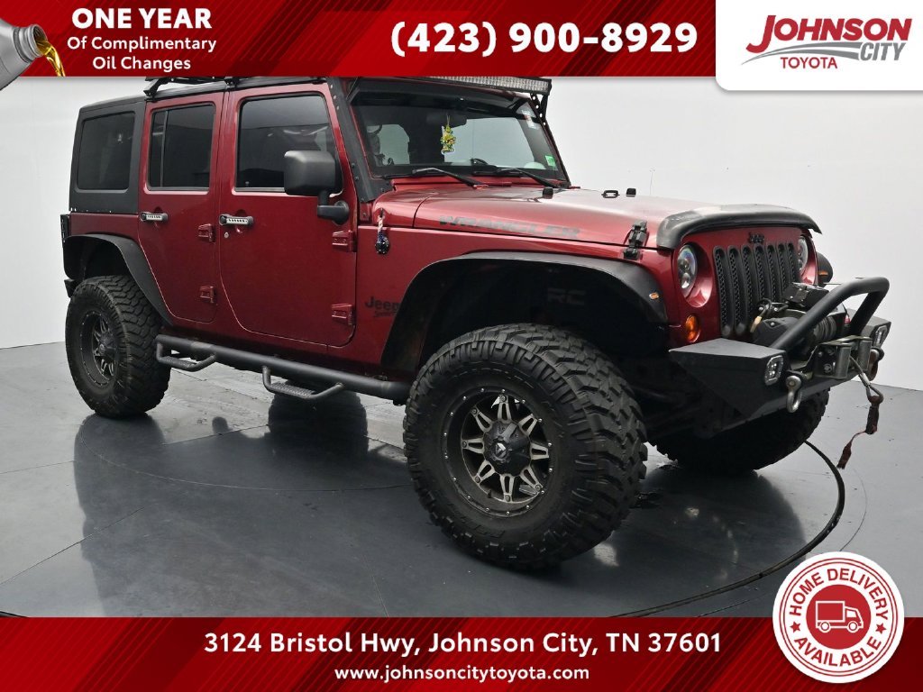 Used 2012 Red Jeep Unlimited Sport image 1