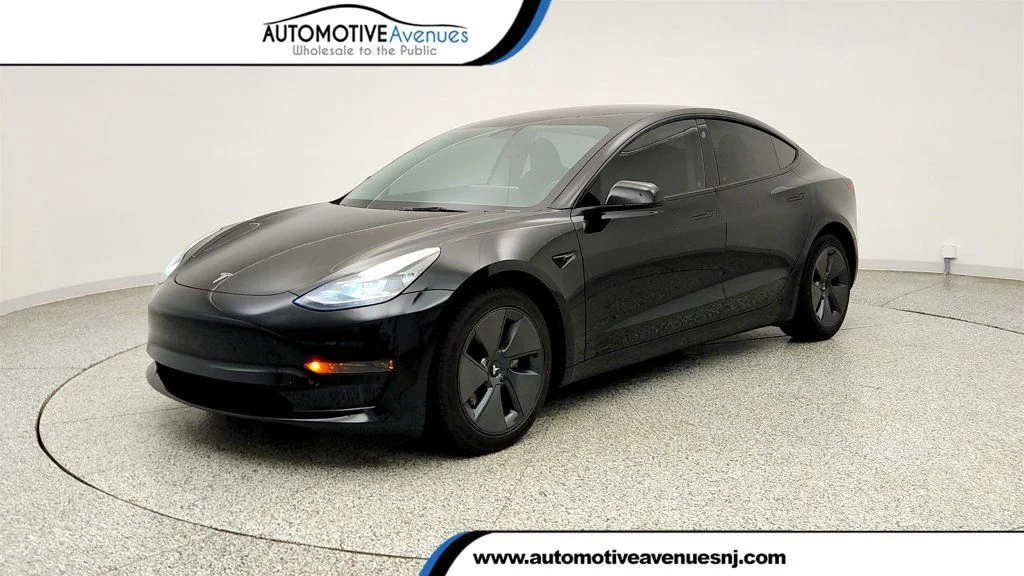 Used 2023 Solid Black Tesla RWD image 1