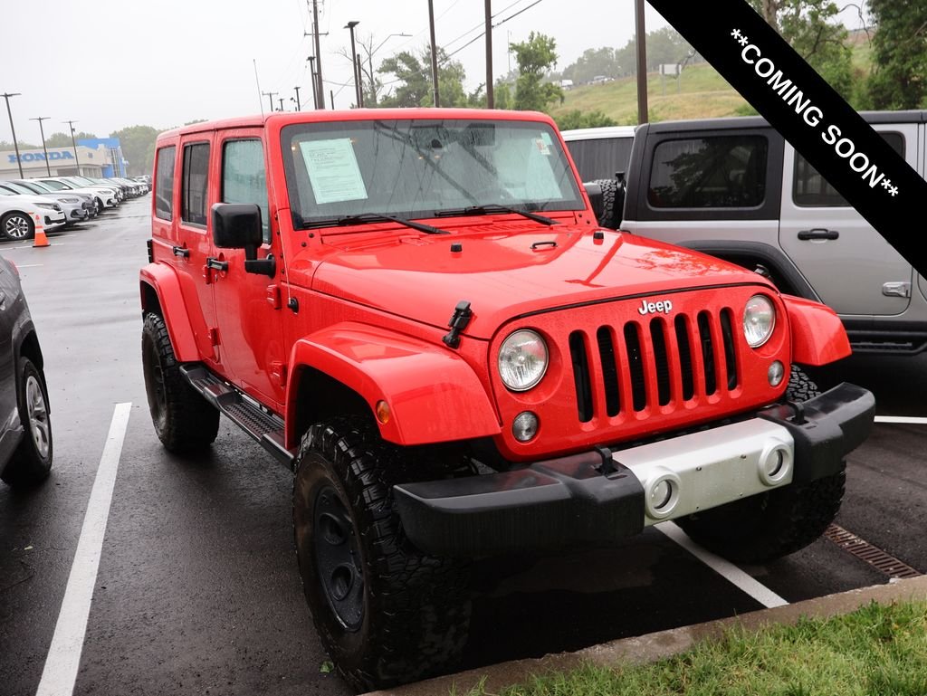 Used 2015 Red Jeep Unlimited Sahara image 1