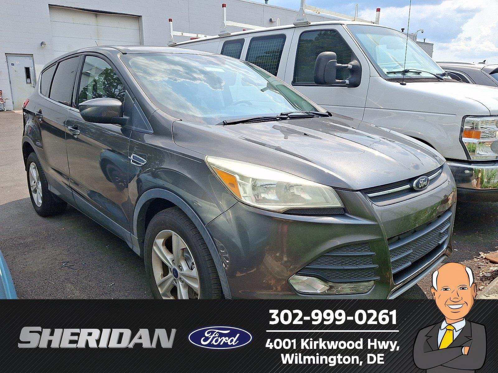 Used 2015 Magnetic Metallic Ford SE image 1