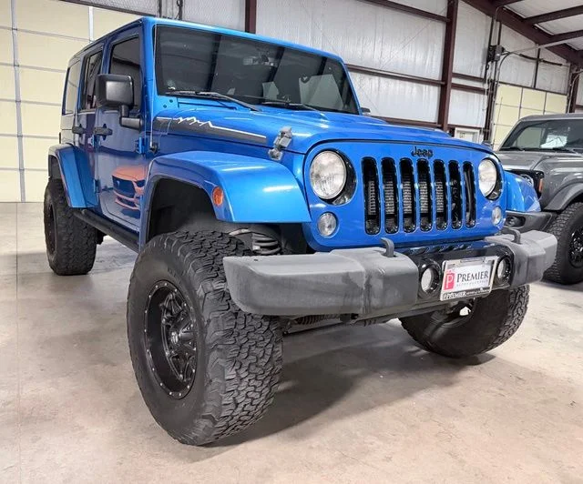 Used 2014 Blue Jeep Unlimited Sahara image 1