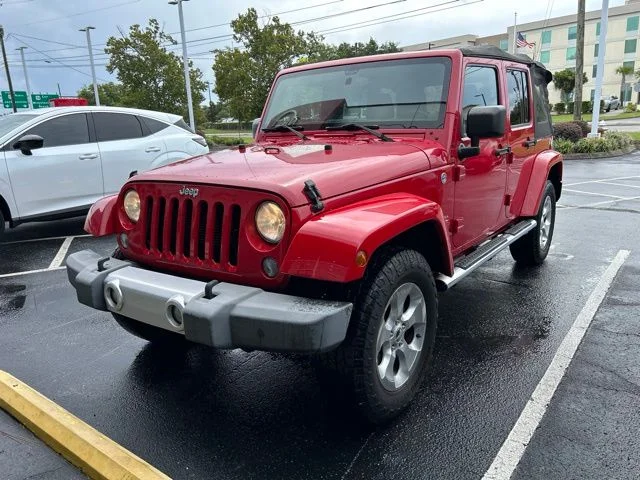 Used 2014 Red Jeep Unlimited Sahara image 1