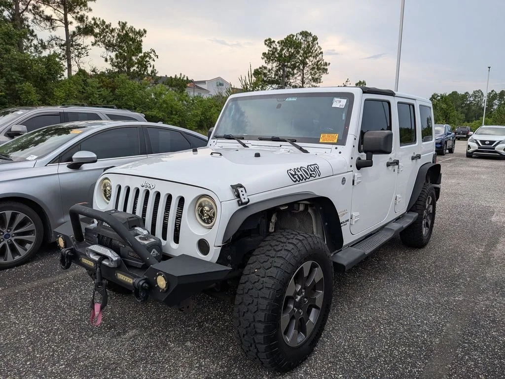 Used 2012 White Jeep Unlimited Sahara image 1