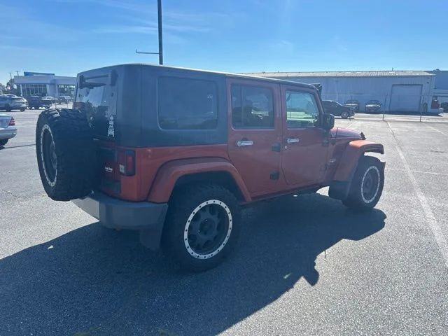 Used 2009 Orange Jeep Unlimited Sahara image 4
