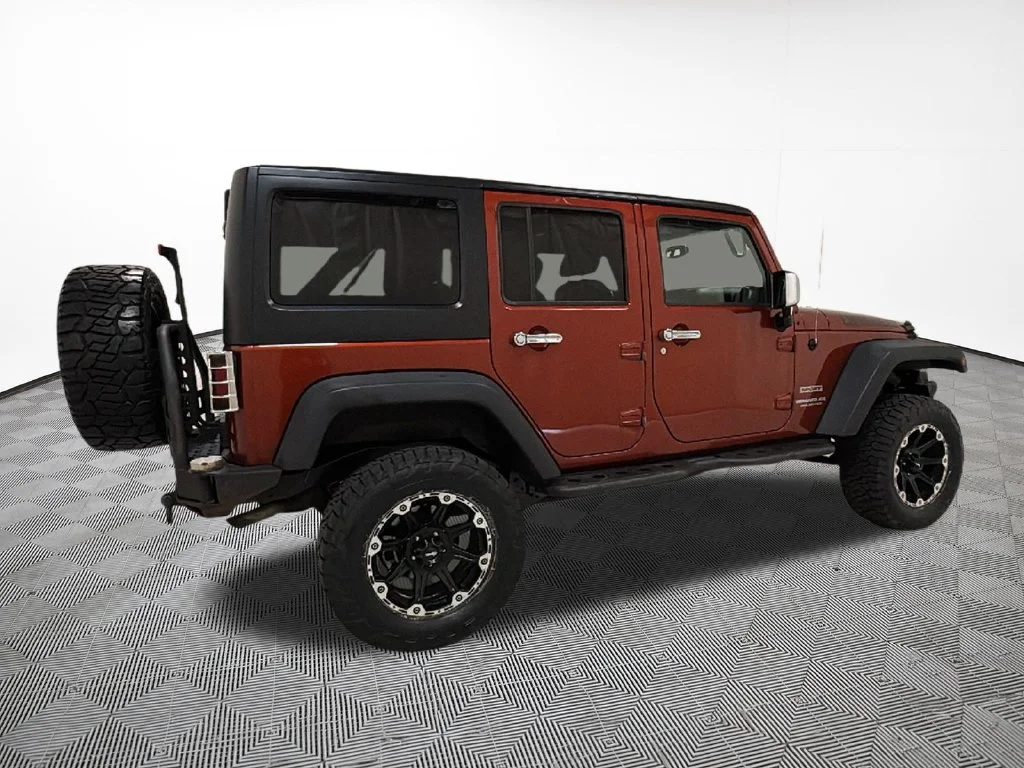 Used 2014 Orange Jeep Unlimited Sport image 9