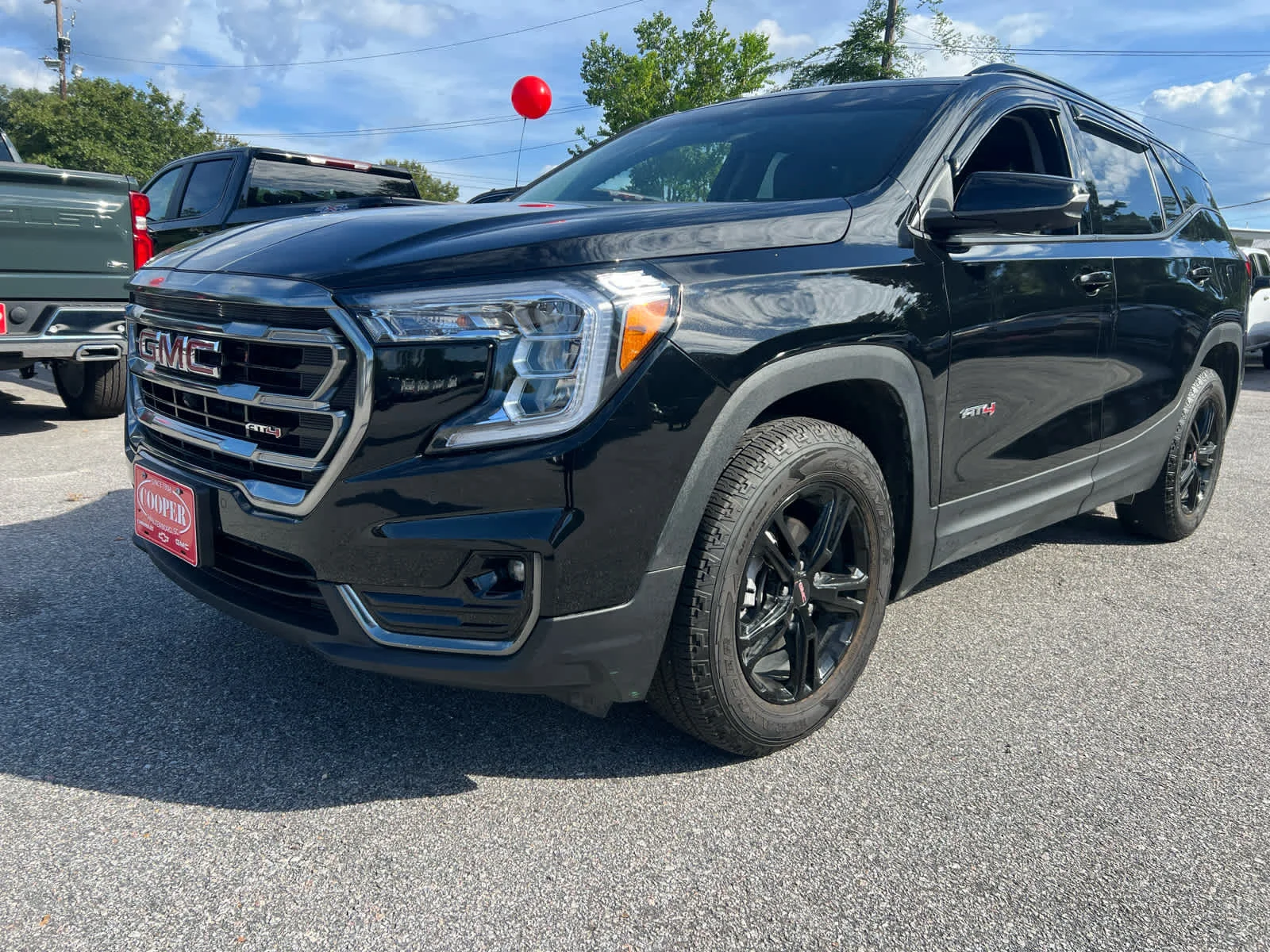 Used 2024 Ebony Twilight Metallic GMC AT4 image 1