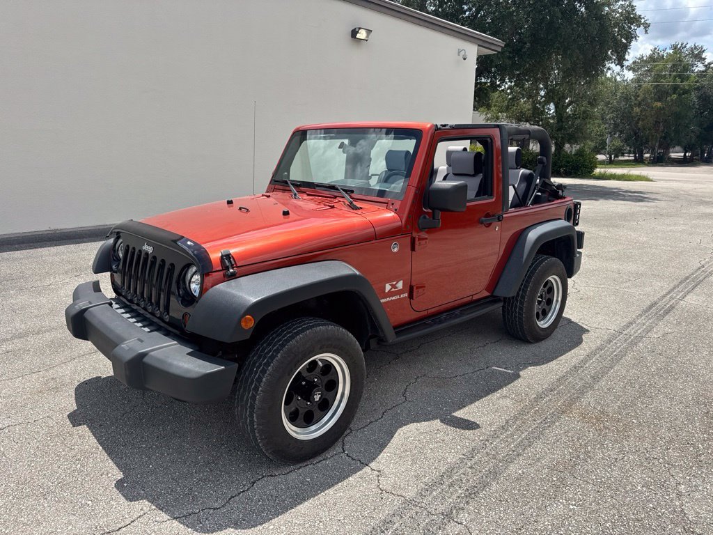 Used 2009 Sunburst Orange Pearl Jeep X image 1