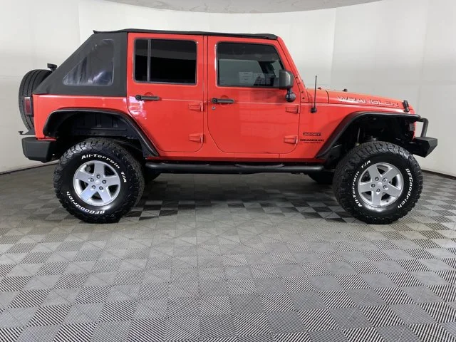 Used 2013 Red Jeep Unlimited Sport image 2