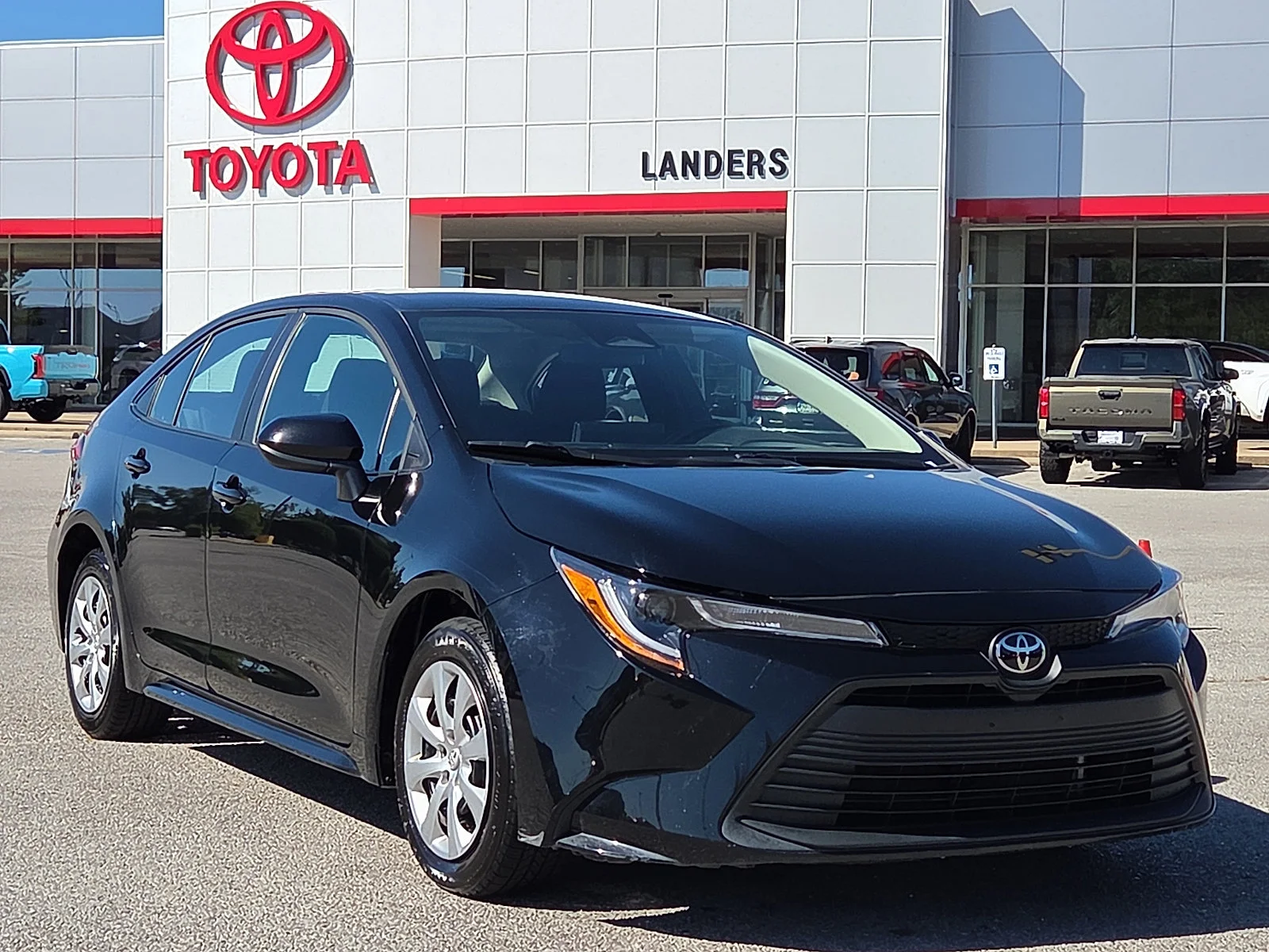 Used 2025 Midnight Black Metallic Toyota LE image 1