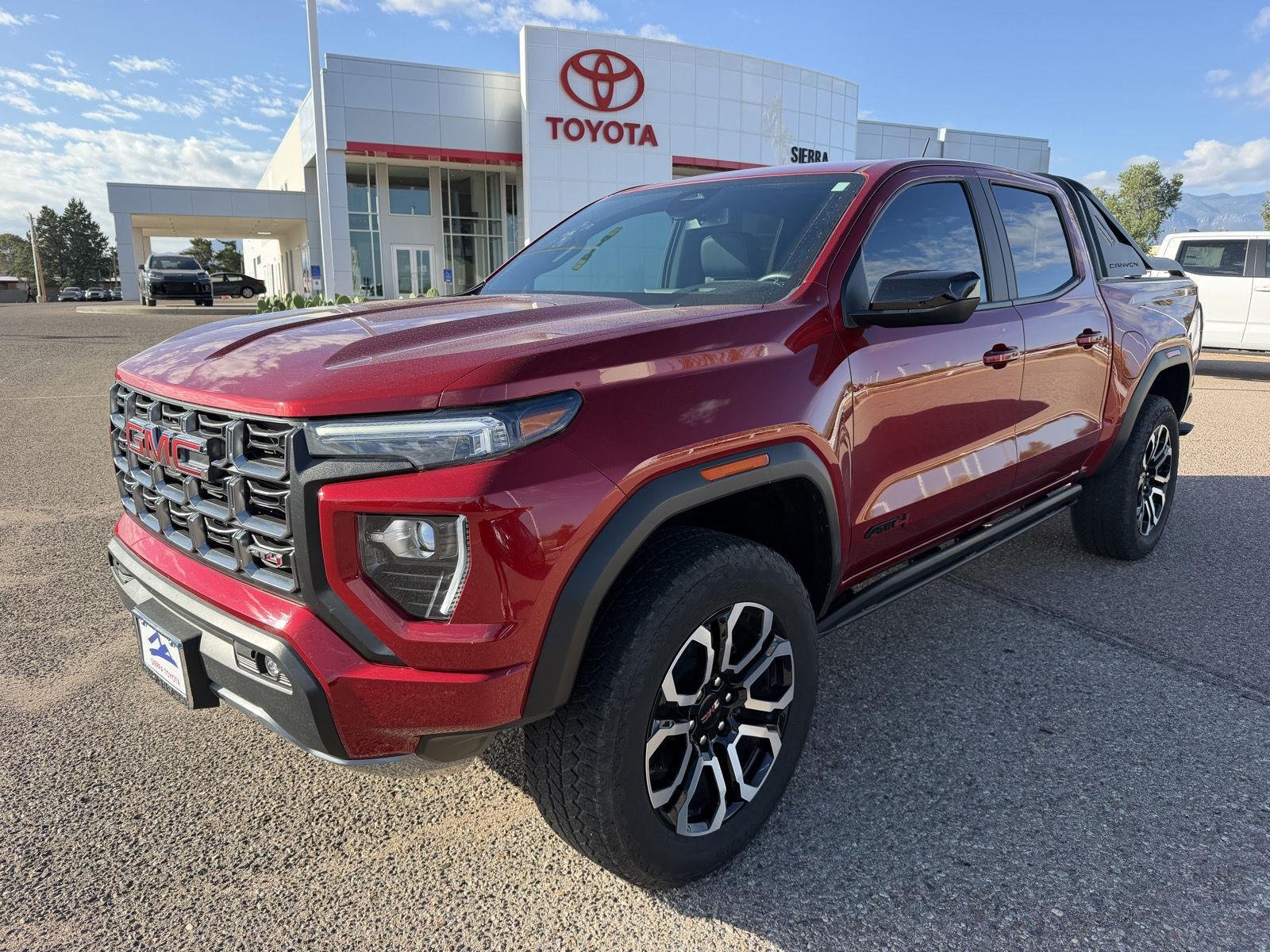 Used 2025 Volcanic Red Tintcoat GMC 4WD AT4 image 1