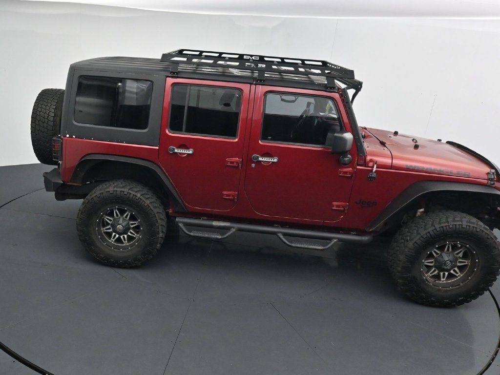 Used 2012 Red Jeep Unlimited Sport image 17