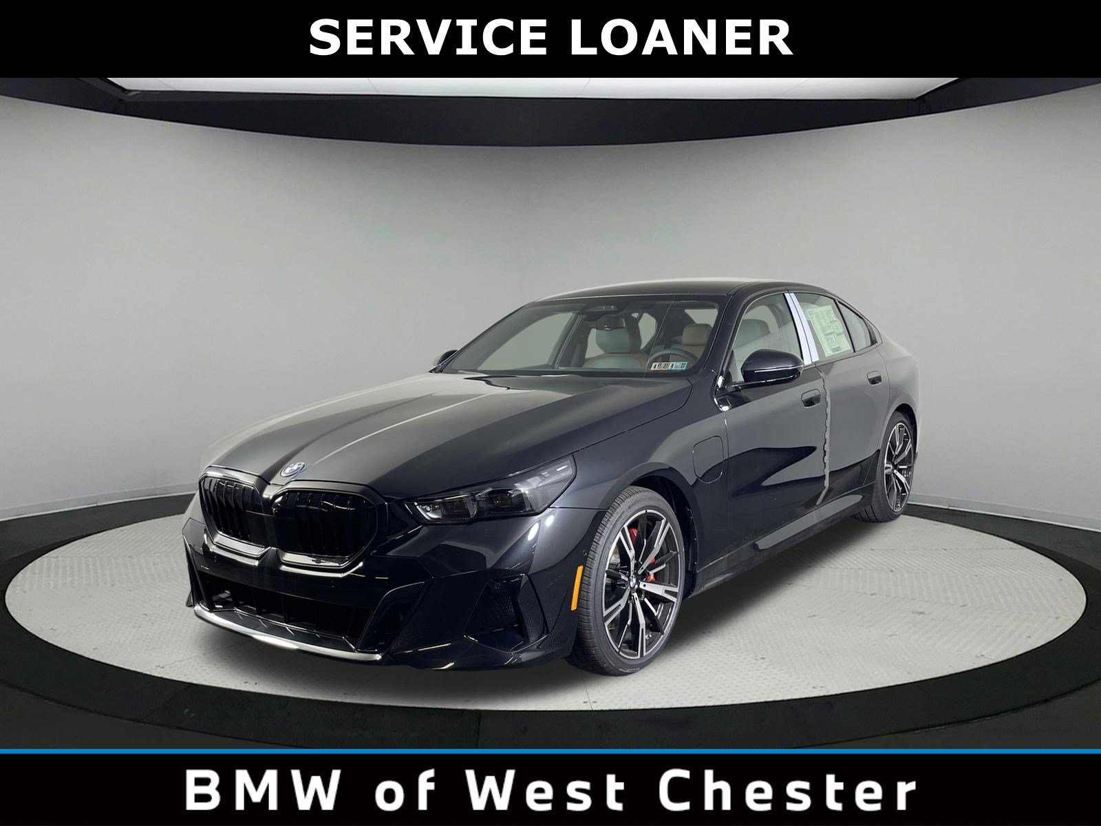 Used 2026 Black Sapphire Metallic BMW 550e xDrive image 1