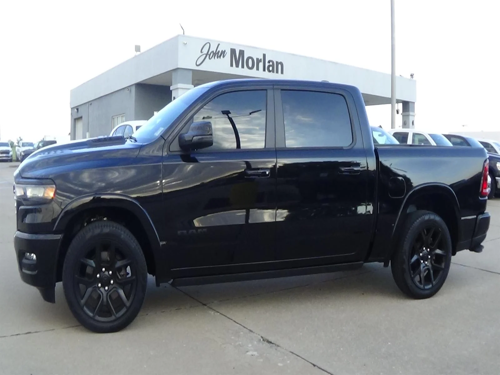 Used 2025 Diamond Black Crystal Pearl Coat (pxj) RAM Laramie image 1