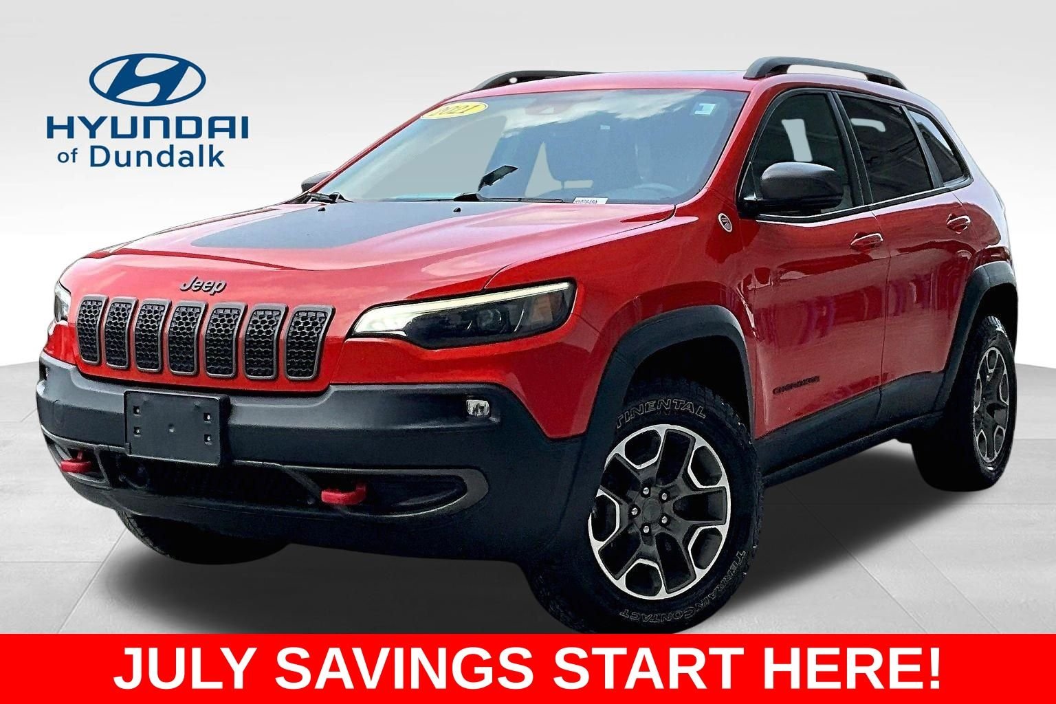 Used 2021 Orange Jeep Trailhawk image 1