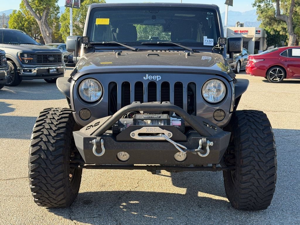 Used 2016 Granite Crystal Clearcoat Metallic Jeep Unlimited Sport image 2