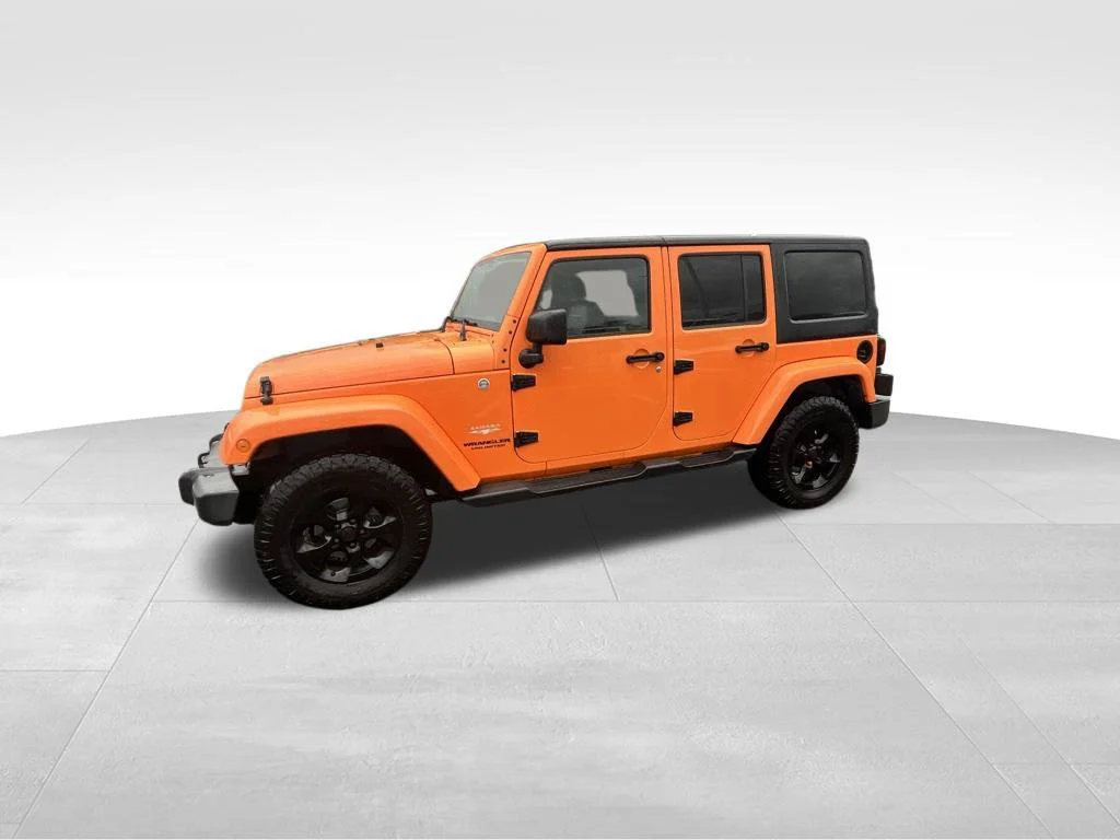 Used 2013 Orange Jeep Unlimited Sahara image 2