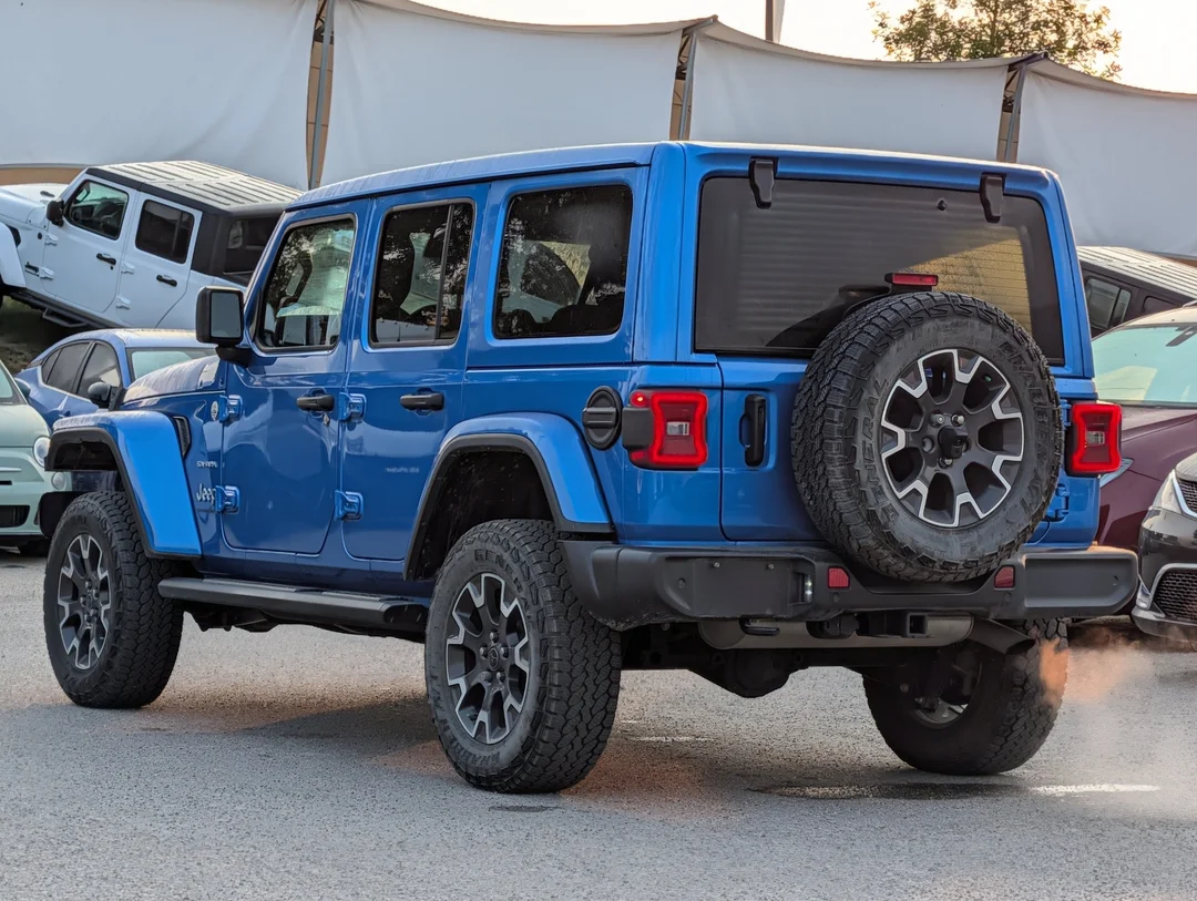 Used 2024 Blue Jeep Sahara - - 4x4 - Leather Seats - Power Soft Top - Remote Start & More! image 6