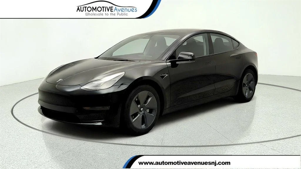 Used 2023 Solid Black Tesla RWD image 1