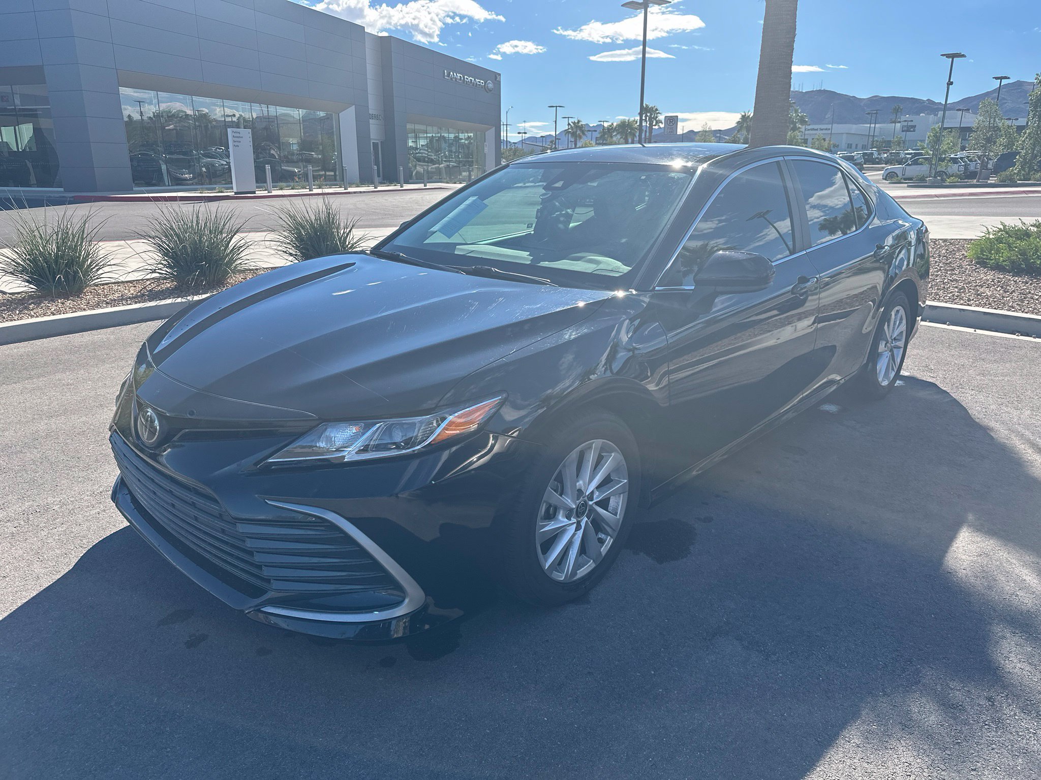 Used 2022 Midnight Black Metallic Toyota LE image 1