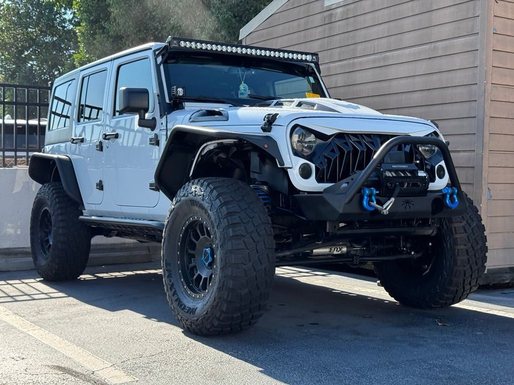 Used 2014 White Jeep Unlimited Sport image 1