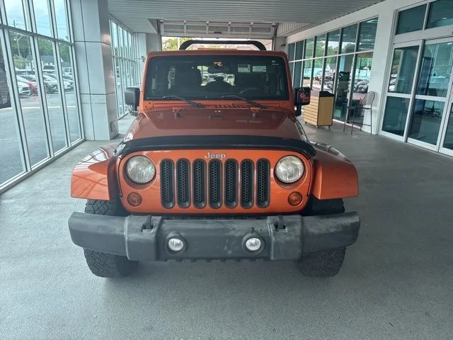 Used 2011 Orange Jeep Unlimited Sahara image 2