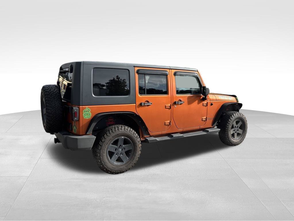 Used 2010 Orange Jeep Unlimited Sport image 4