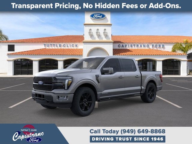Ford trucks and SUVs lined up at a dealership lot in California