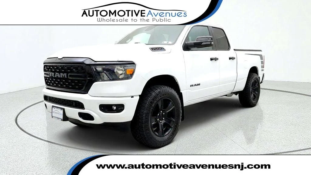 Used 2023 Bright White Clearcoat Ram Big Horn Quad Cab 4x4 Night Edition w/ HEMI V8 & Level 2 Group image 1