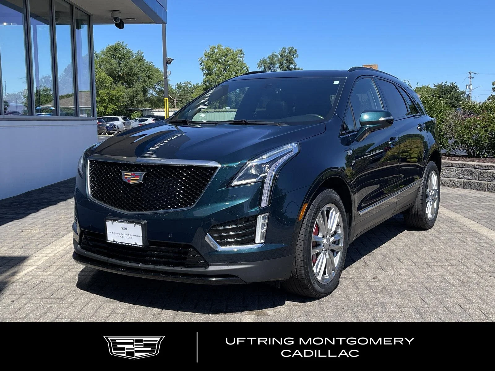 Used 2024 Emerald Lake Metallic Cadillac Sport image 1