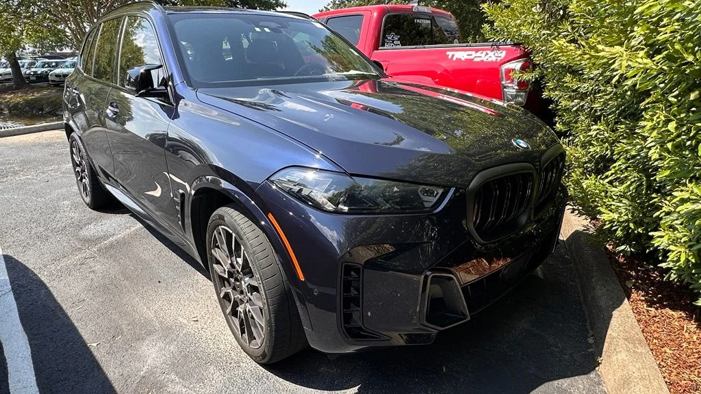 Used 2024 Black Sapphire Metallic BMW M60i image 1