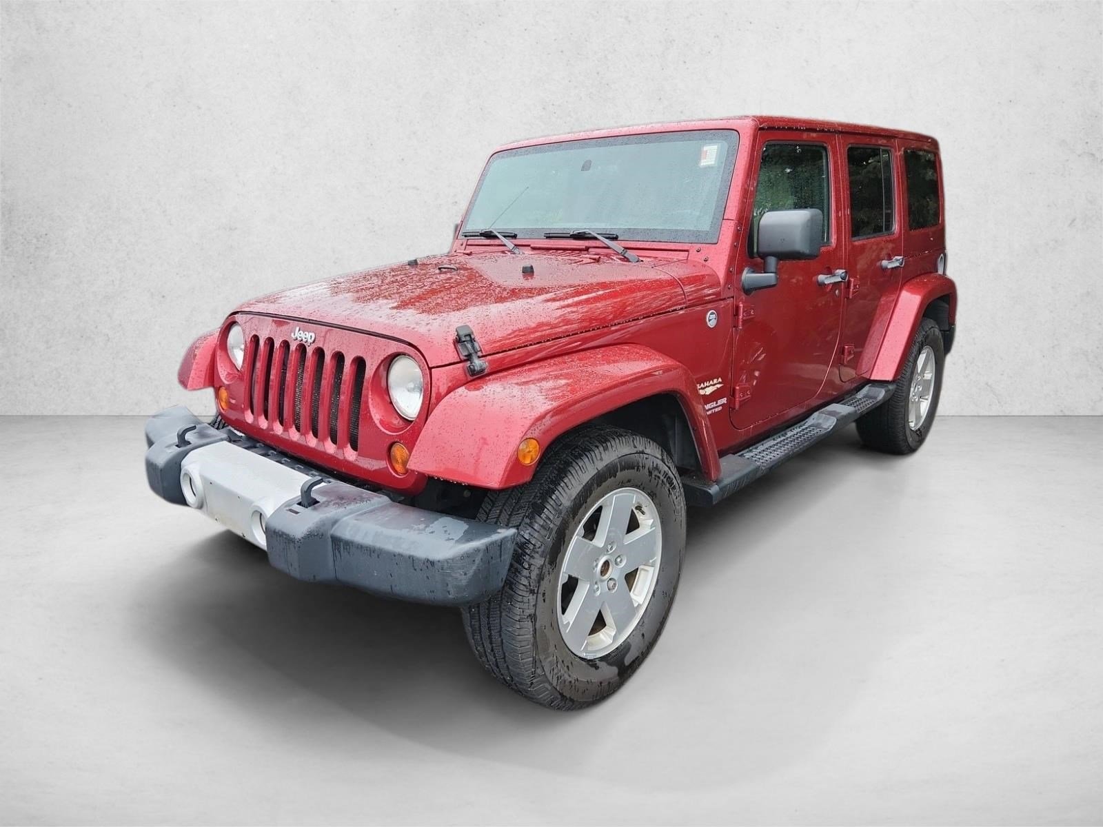 Used 2012 Deep Cherry Red Crystal Pearl Jeep Sahara image 1