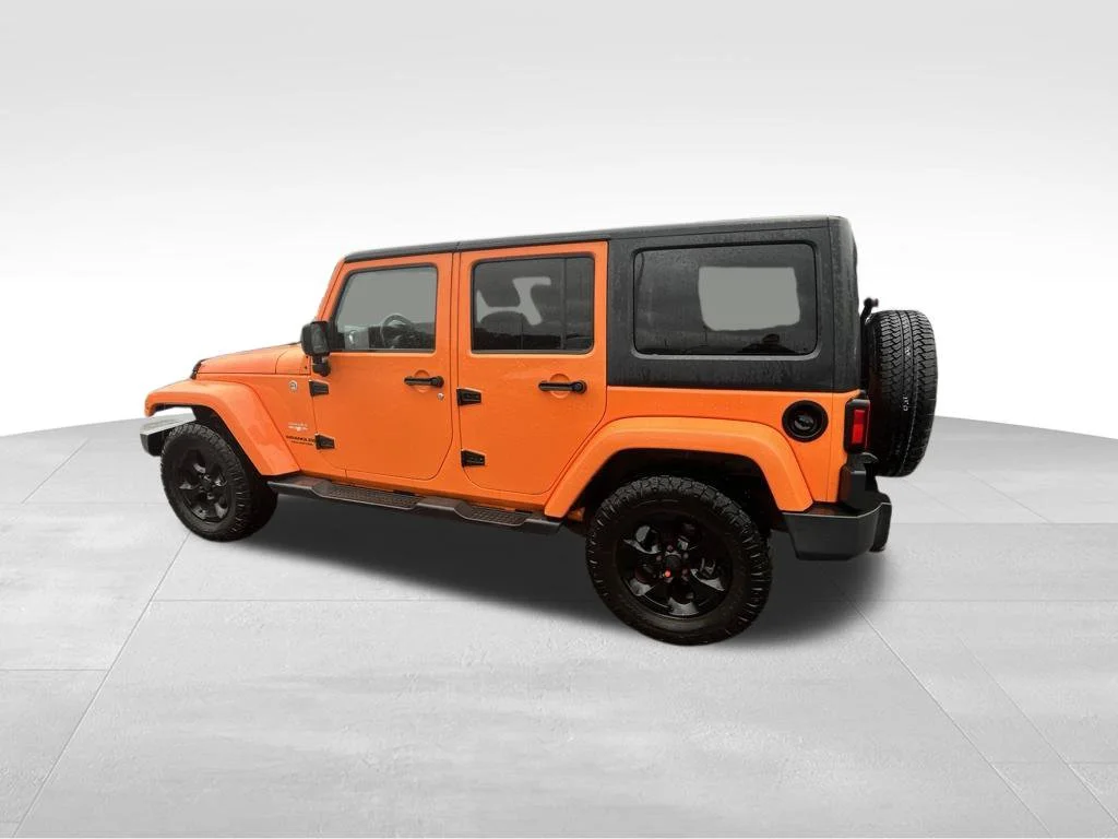 Used 2013 Orange Jeep Unlimited Sahara image 8