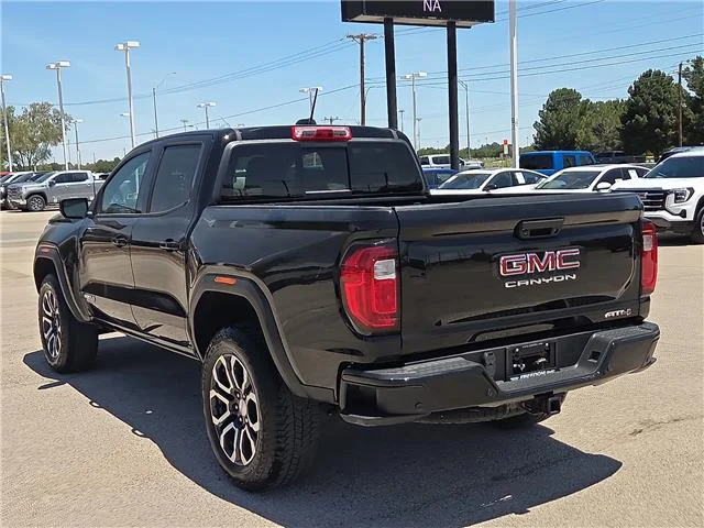 Used 2024 Onyx Black GMC AT4 4x4 Crew Cab 5 ft. box 131 in. WB image 2