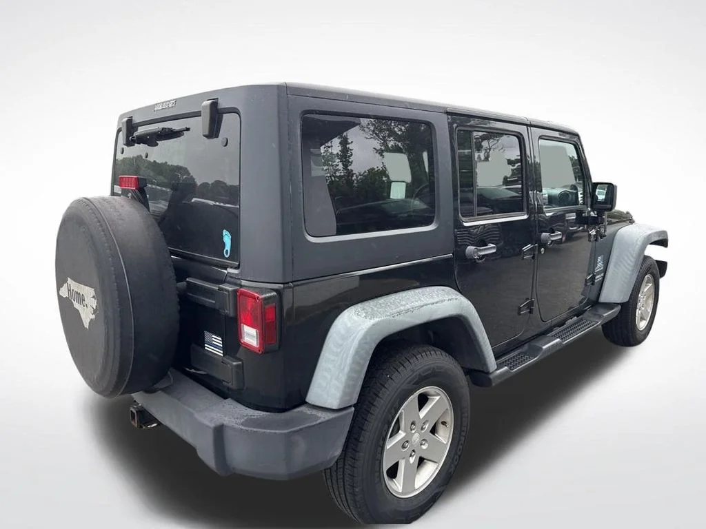 Used 2012 Black Jeep Unlimited Sport image 13