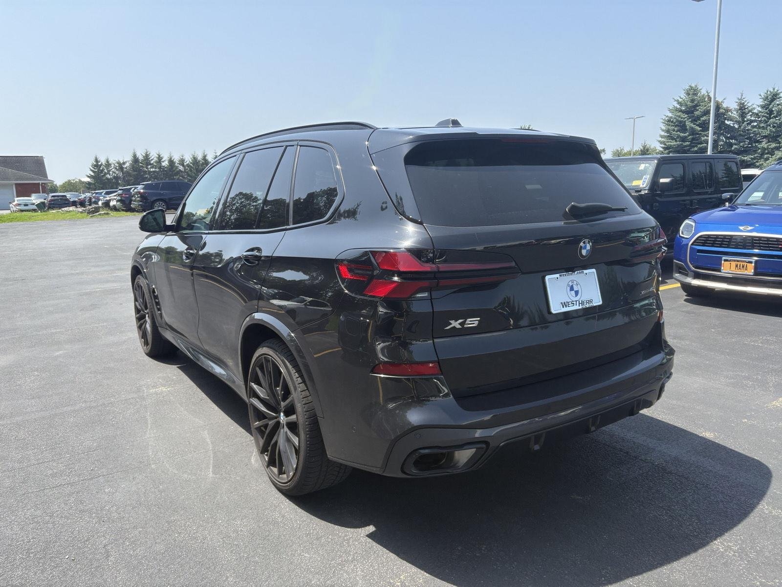 Certified Used 2025 Black Sapphire Metallic BMW xDrive40i image 4
