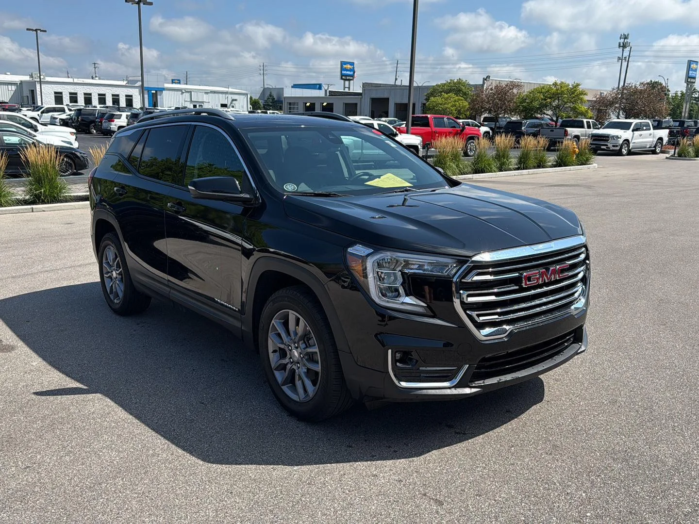 Used 2024 Ebony Twilight Metallic GMC SLT image 1