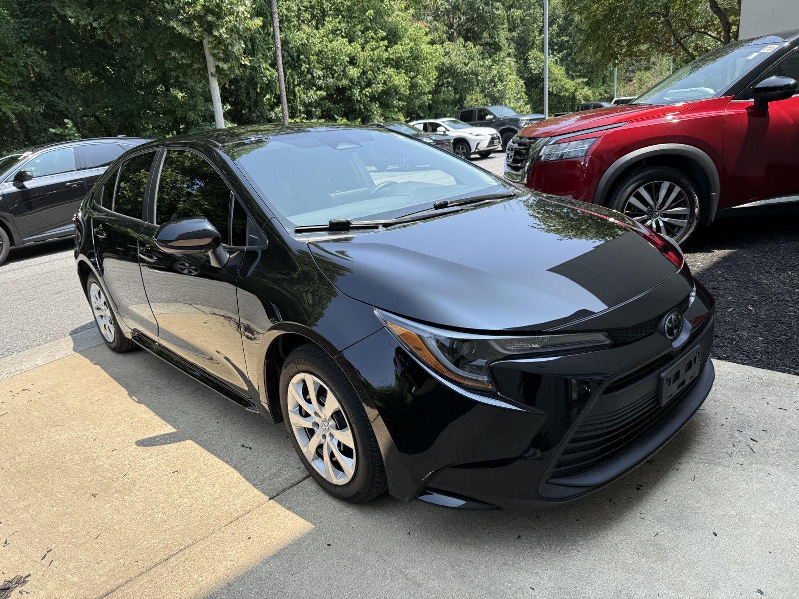 Used 2023 Midnight Black Metallic Toyota LE image 1
